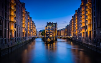 canal between buildings during nighttime
