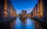 canal between buildings during nighttime