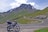 A scenic view of a motorcycle parked on a winding road.