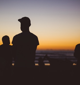 silhouette group of people under sunset