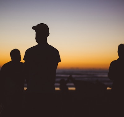 silhouette group of people under sunset