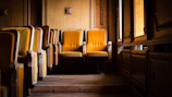 A cozy vintage cinema seat bathed in warm light, evoking the charm of timeless films