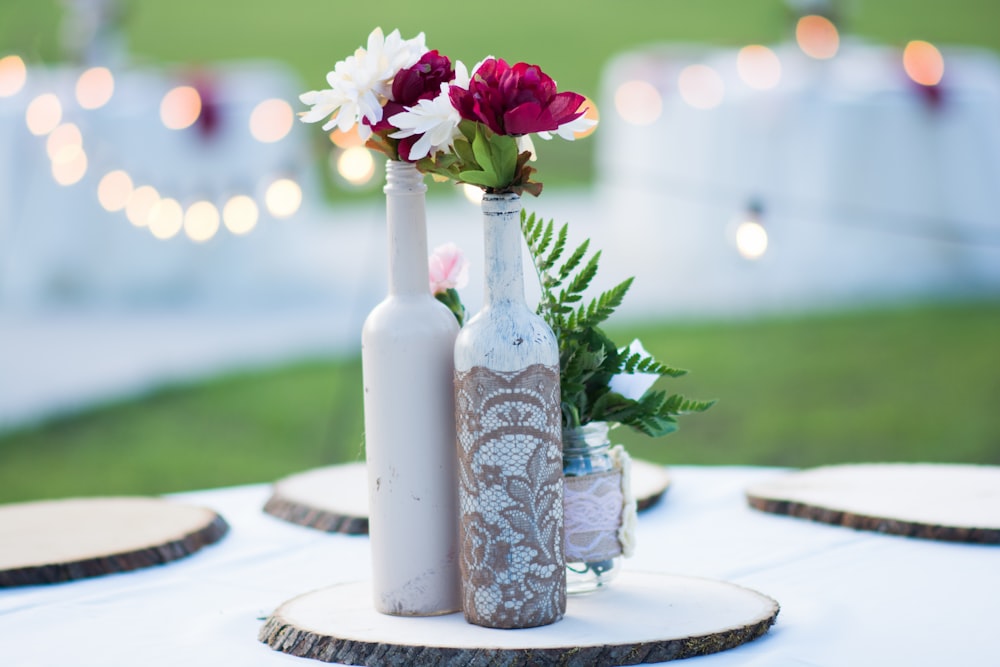 pink flowers in white and blue floral ceramic vase