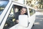 man in gray sweater leaning on van window