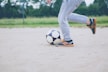 person plays soccer ball on white sands