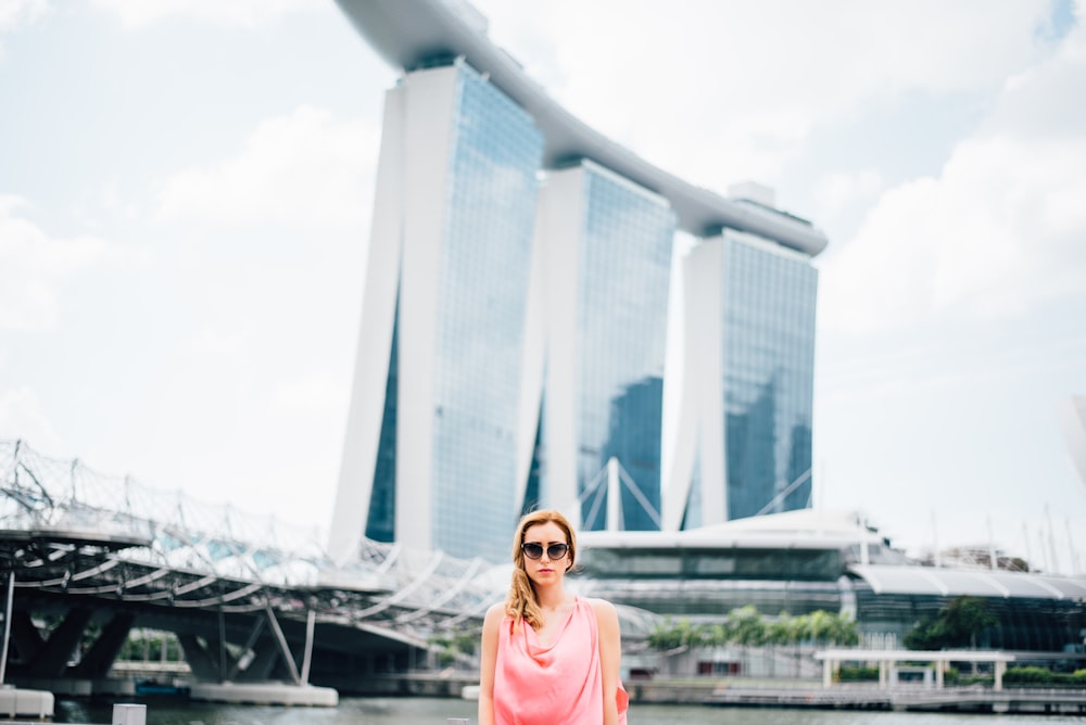 woman standing in front of gray concrete structure