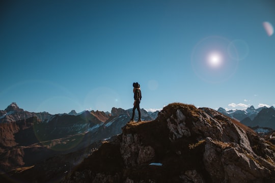 person standing on the cliff in Nebelhorn Germany