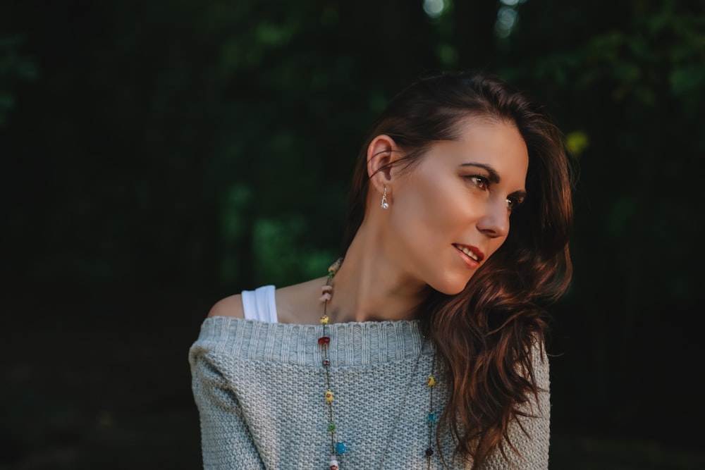 shallow focus photography of woman in gray sweater