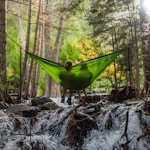 two person on green mesh hammock outdoor