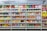 A supermarket aisle filled with a variety of colorful packaged snacks arranged on metal shelving units. Different brands and flavors of chips and other snacks are prominently displayed, creating a vibrant and diverse display of products.