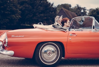 two person riding vintage coupe