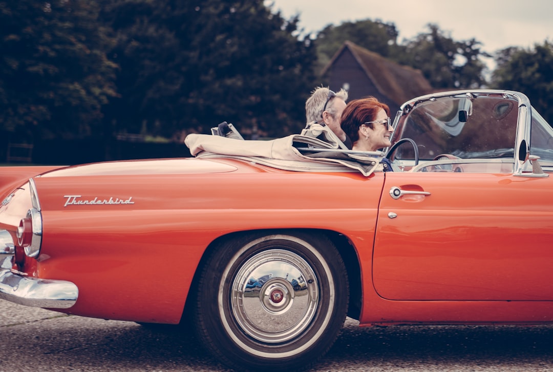 two person riding vintage coupe,