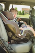 A child being secured in a car seat.