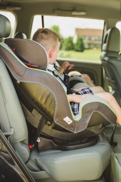 A child being secured in a car seat.