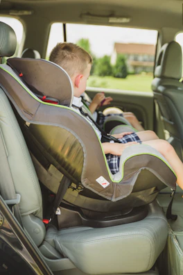 Close-up of a child safety monitoring device installed in a car seat.