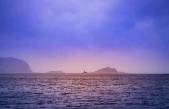 body of water near mountain in Ålesund Norway