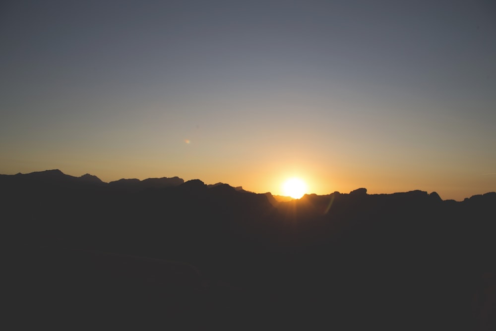 silhouette of mountain during sunset