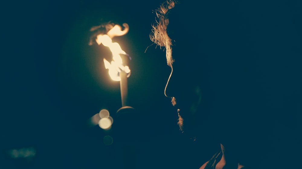 man standing in front of candle