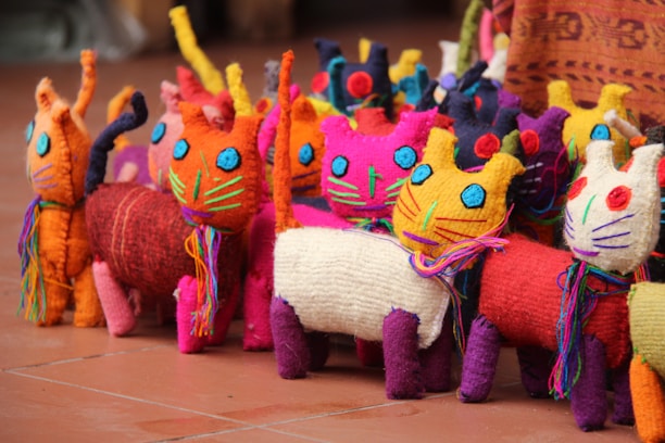 Close-up of a colorful handmade cat toy with intricate stitching and bright fabric patterns.