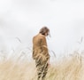 person standing in the middle of wheat field feeling regret from not choosing the right vendor. 