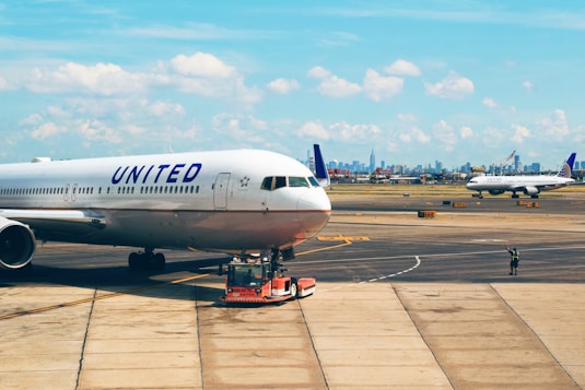 white United plane parked on ramp