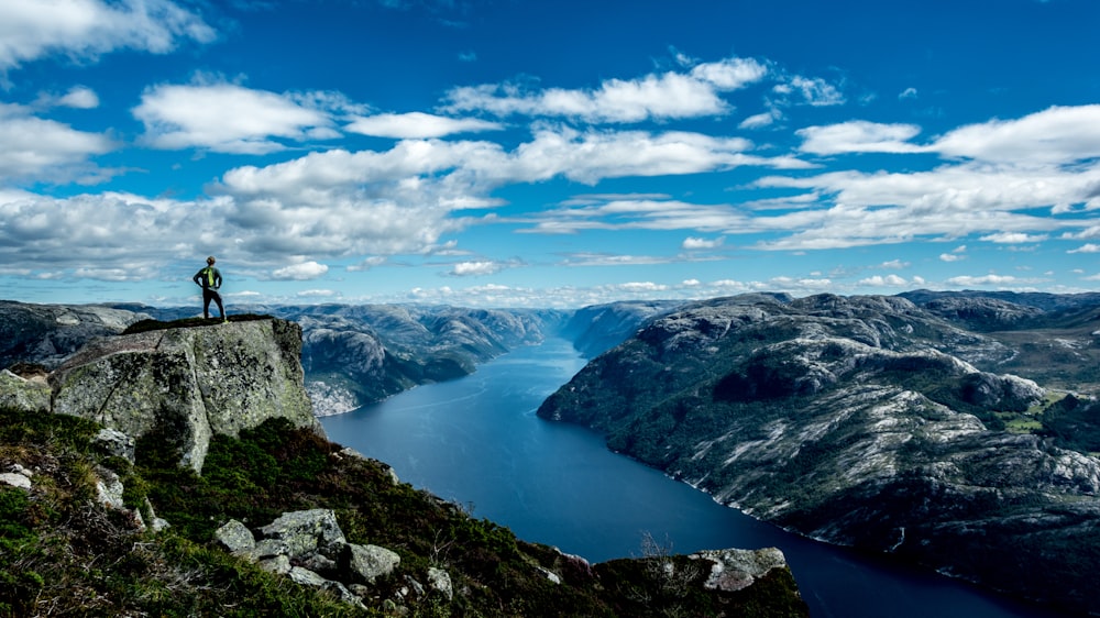 man standing on top of a mountain