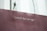 A maroon paper bag with a white rope handle features the quote 'youth has no age' printed in white lettering.