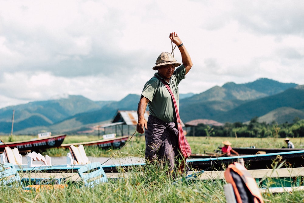 man wearing hat near boat