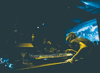man playing audio mixer in club