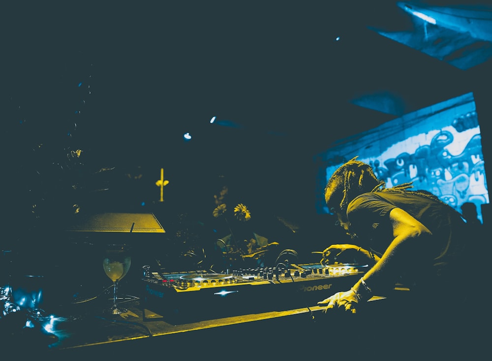 man playing audio mixer in club