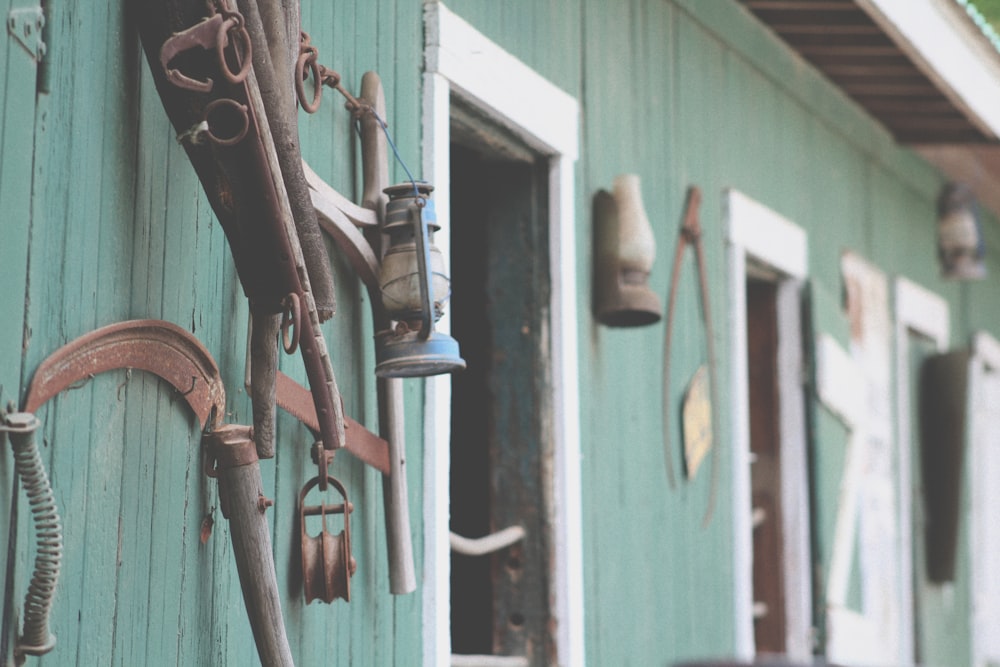 blue kerosene lamp hanged on wall rack