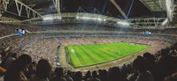 Packed stadium crowd watching a live football match