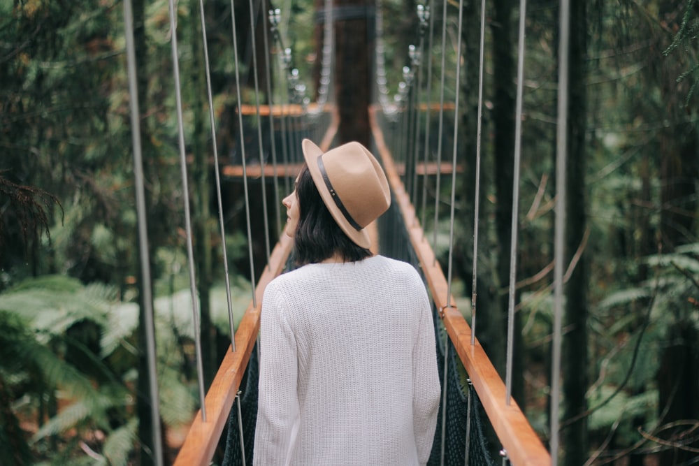 woman walking on bridge while looking around