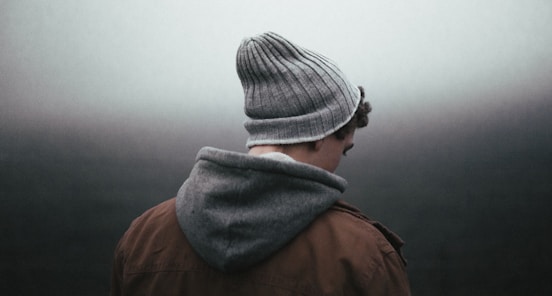 man wearing knit cap on grey background