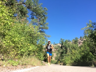 An active person jogging on a scenic trail surrounded by nature.