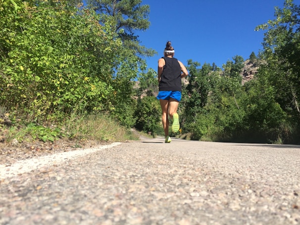 A runner in motion wearing breathable sneakers on a sunny day.