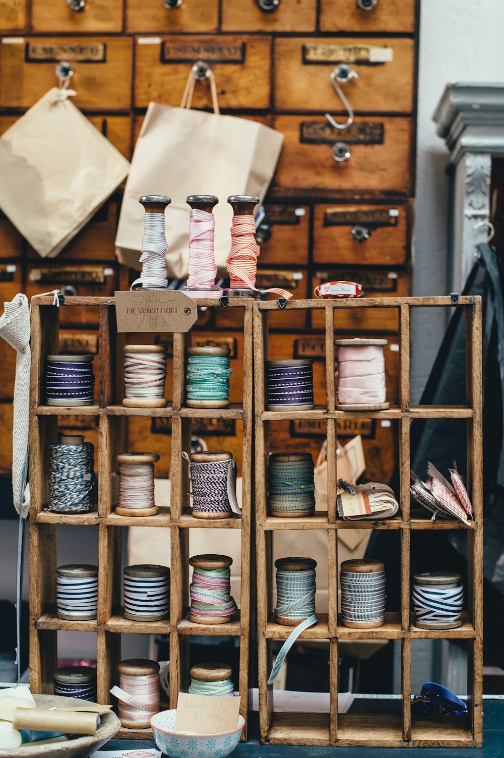 Colorful spools of thread in a wooden organizer