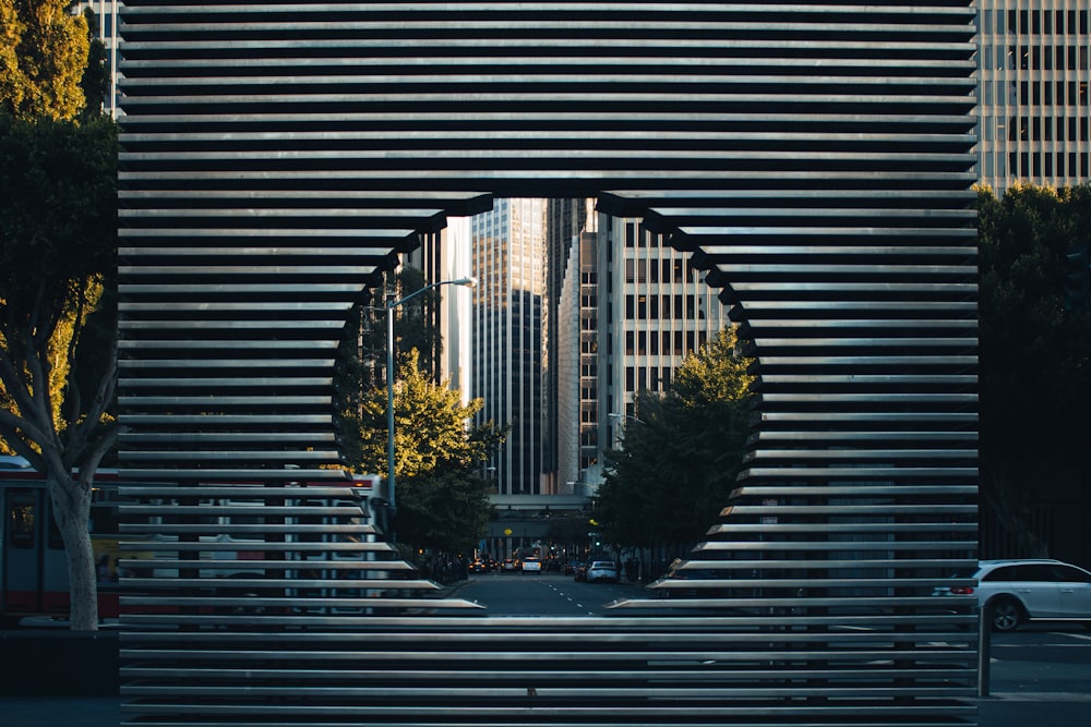 gray concrete building with hole near green trees during daytime