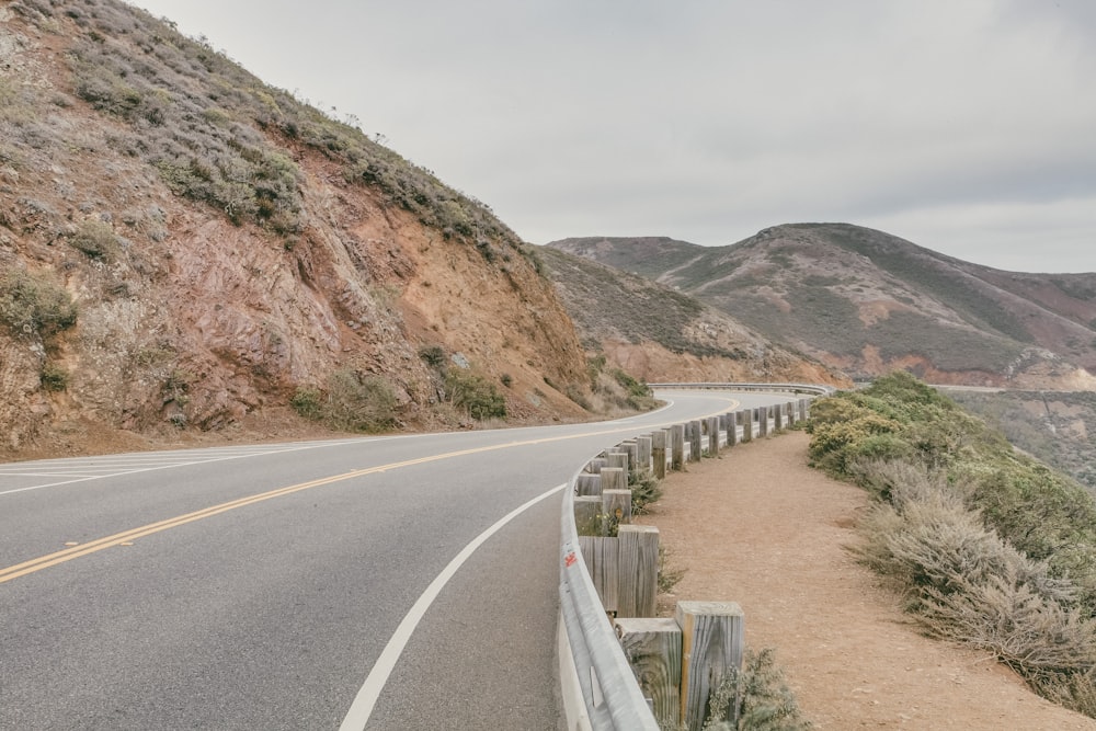 curved road beside mountain