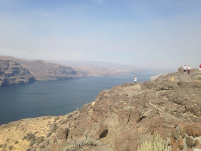 Travelers enjoying a scenic view from a cliff.