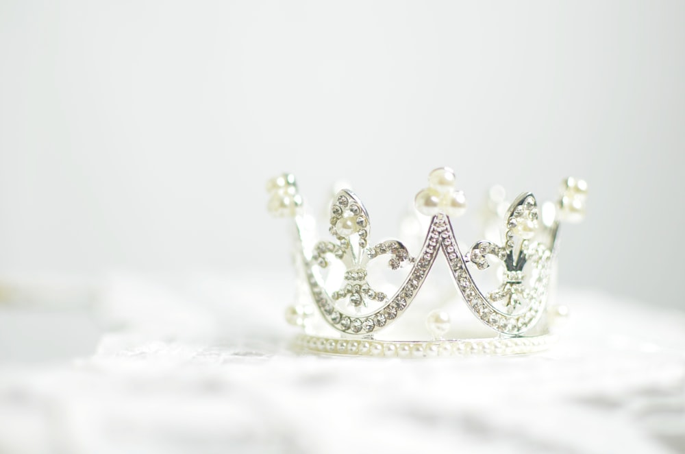 shallow photography of silver-colored crown