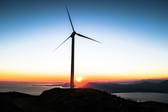 silhouette of wind mill during golden hour