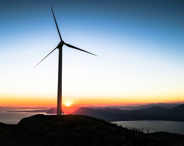 silhouette of wind mill during golden hour