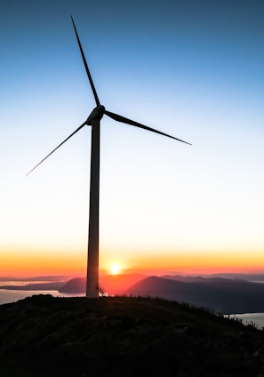silhouette of wind mill during golden hour
