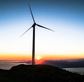 silhouette of wind mill during golden hour