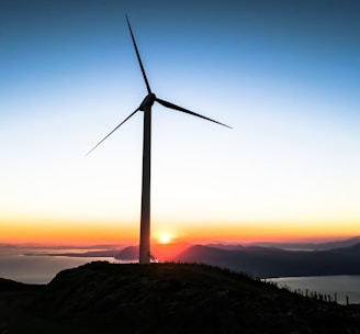 silhouette of wind mill during golden hour