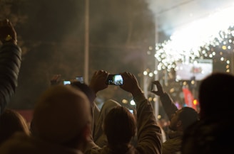A group of friends outdoors, eyes on the sky, with phones in hand showing the eclipse timer app.