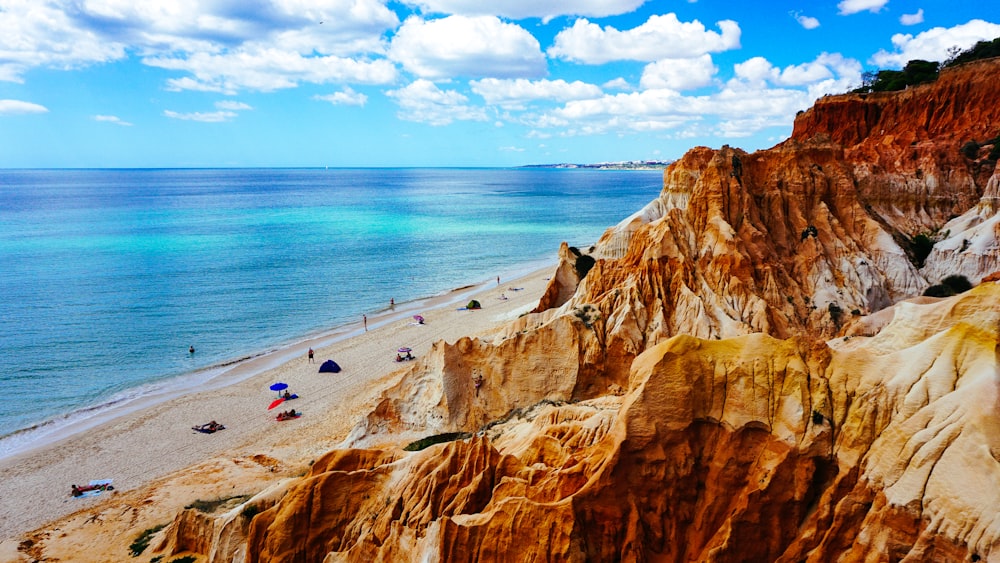 landscape photography of rock formation near body of water