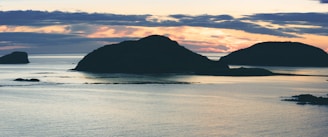 A serene sunset view over the protected marine area of Isla Isabel with calm waters and silhouetted islands.