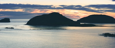 A serene sunset view over the protected marine area of Isla Isabel with calm waters and silhouetted islands.